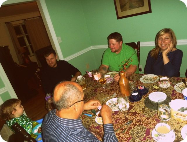 Friends and family around a dining table on Thanksgiving