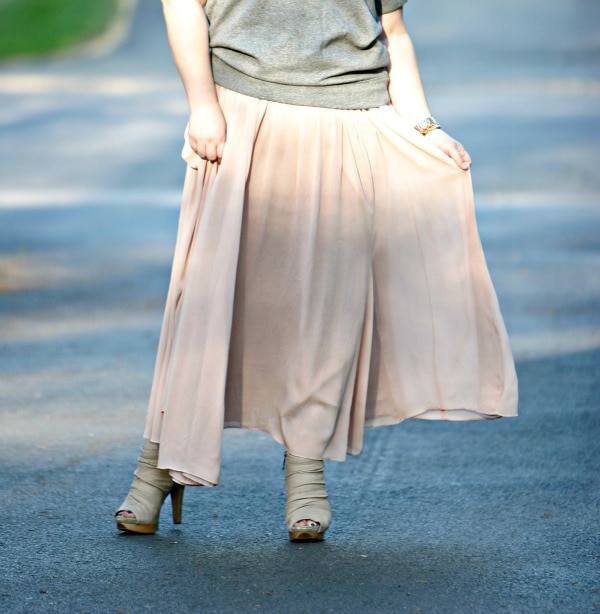 woman in a ballet pink chiffon maxi skirt and beige peeptoe booties