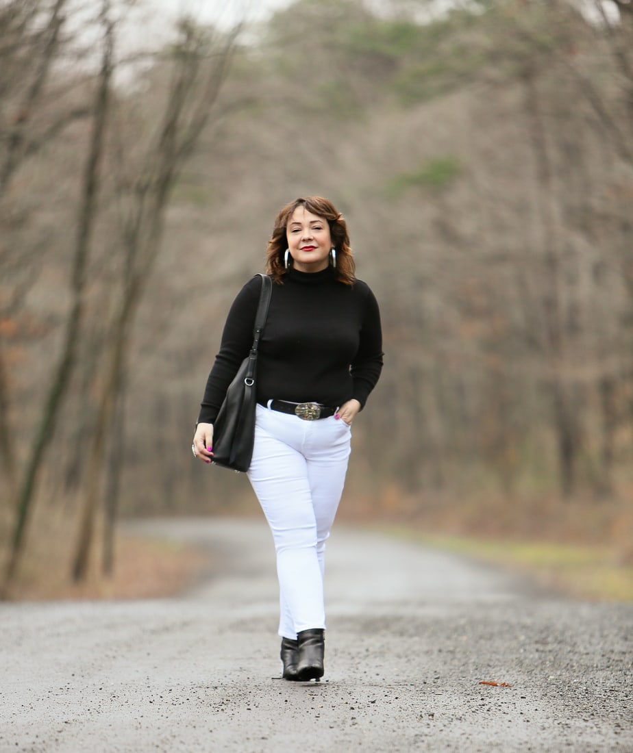 Black Coolmax turtleneck and white stain resistant jeans from Chico's styled on Wardrobe Oxygen with black Clarks ankle boots and the ALLSAINTS North/South tote