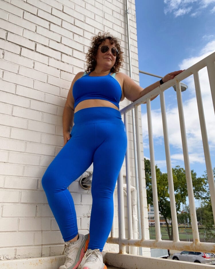A middle-aged woman in ill-fitting activewear in an outdoor stairwell at Union Market in Washington DC.