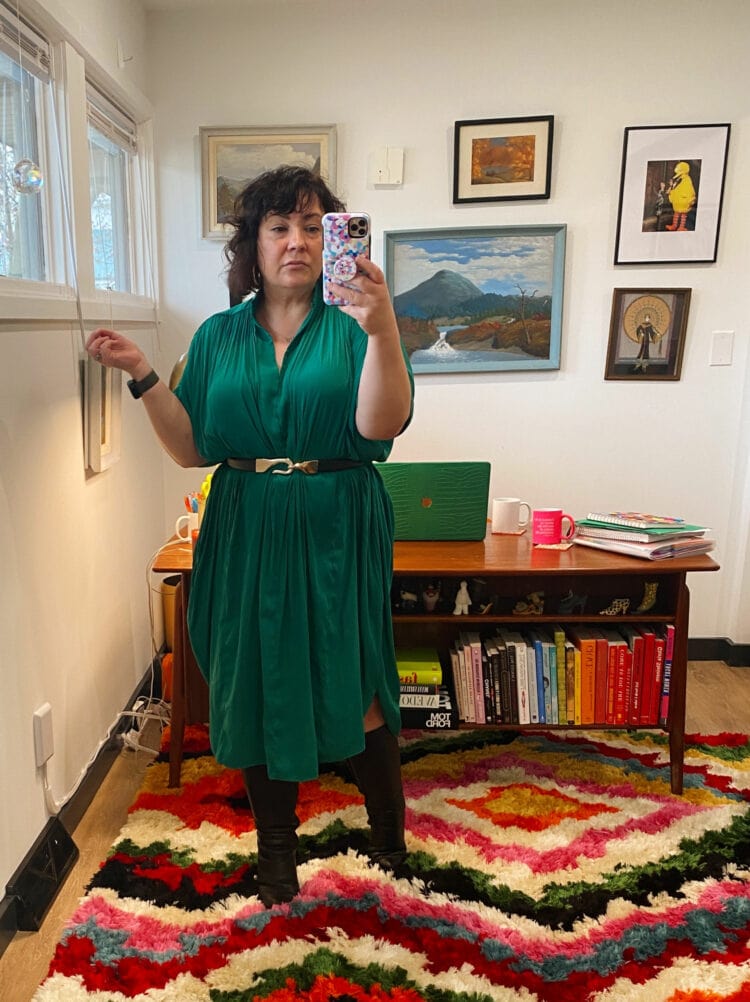 Alison Gary of Wardrobe Oxygen in a green ever by X dress styled with a Chico's black leather and gold belt and black knee-high boots