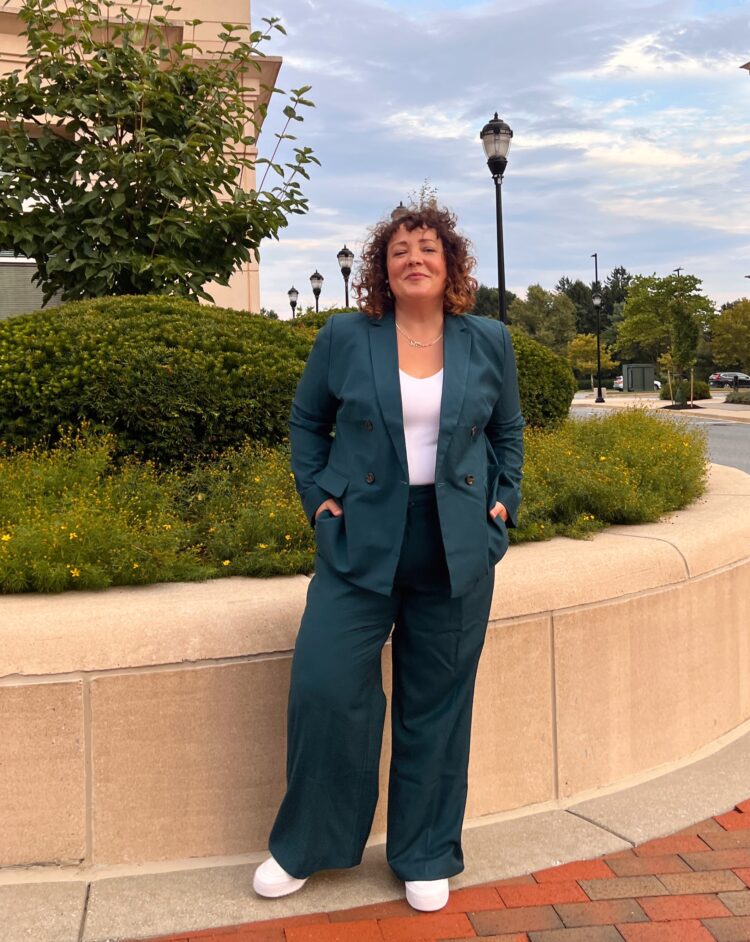 Alison Gary of Wardrobe Oxygen in a teal double breasted pantsuit from Ann Taylor over a white ribbed tank from Athleta and white Adidas superstar sneakers