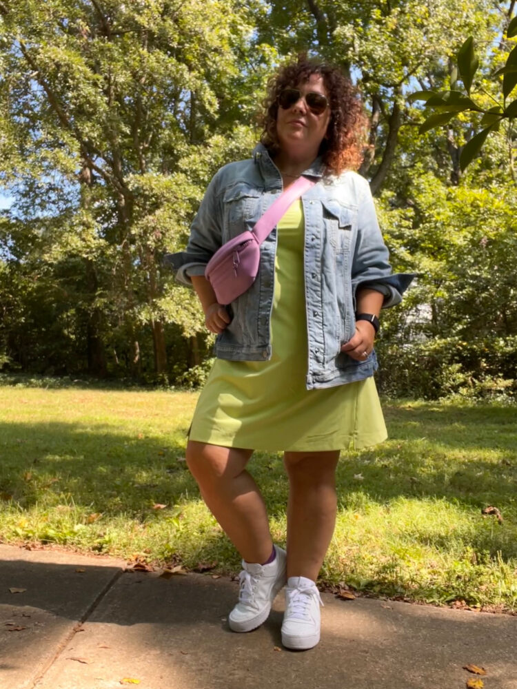 Alison Gary of Wardrobe Oxygen in an Old Navy active skort dress, a lavender belt bag as a crossbody, and a Universal Standard denim chore jacket