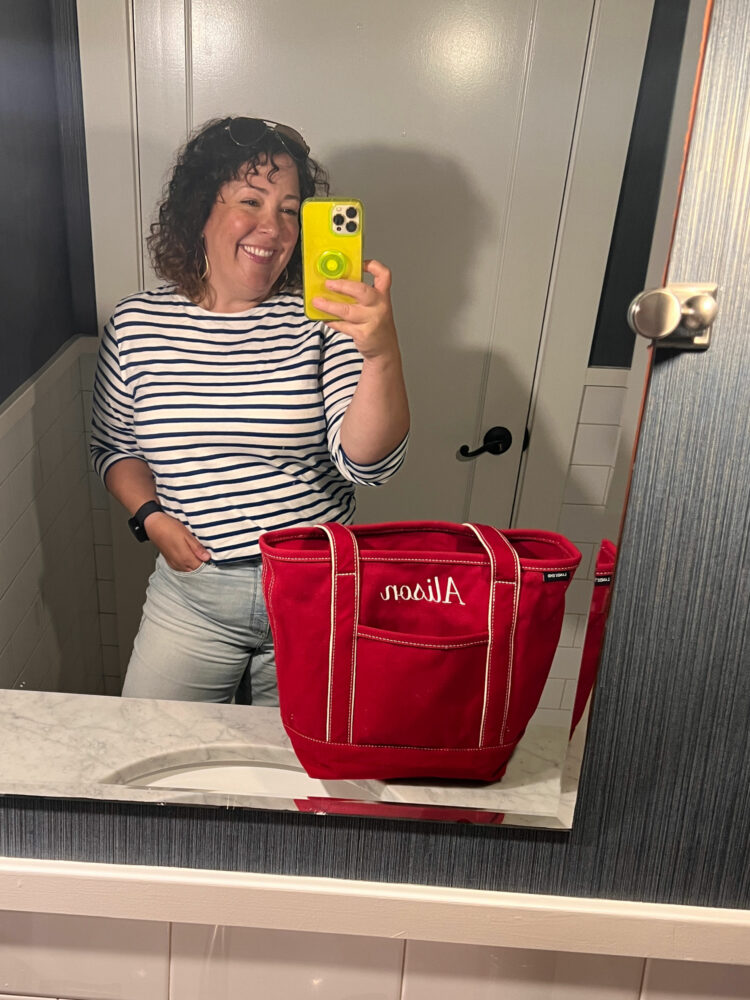 Alison Gary of Wardrobe Oxygen in a Breton striped top from Saint James carrying a red Lands' End canvas tote monogrammed with her name