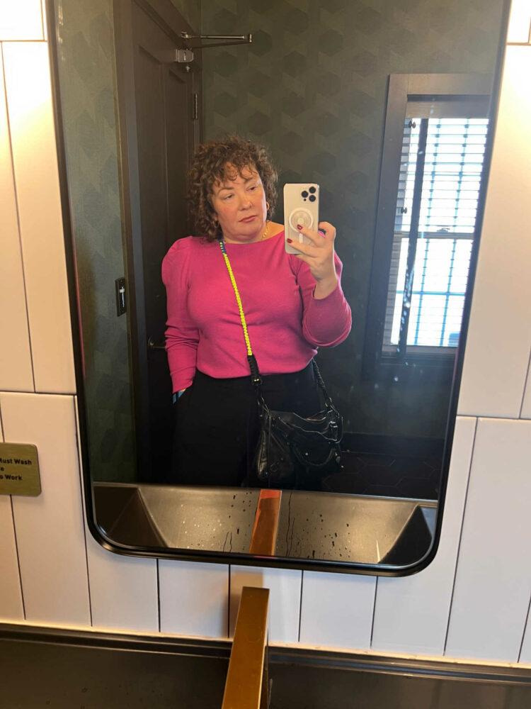 Alison in a pink puffed sleeve sweater from Ann Taylor and black cropped pants from M.M. LaFleur