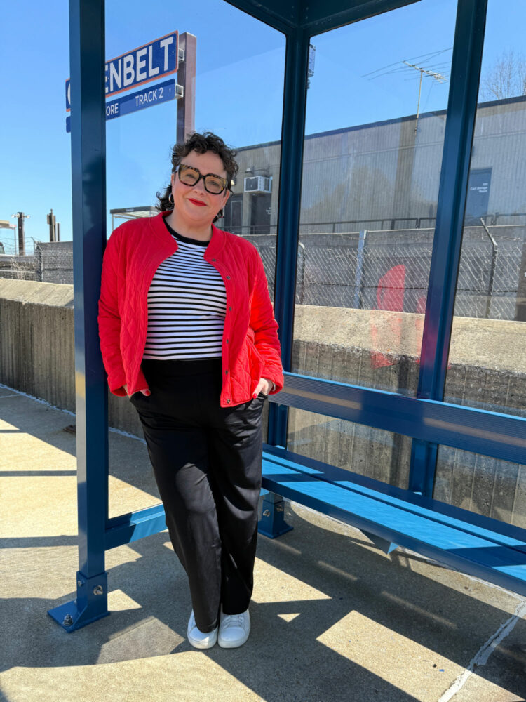 Alison Gary of Wardrobe Oxygen wearing a red quilted jacket, black and white striped tee, and black pants from her Spring travel Capsule Wardrobe with Talbots