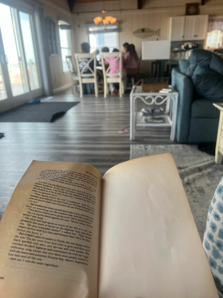 the last page of a paperback novel and in the background several teen girls are sitting around a dining table crafting bracelets