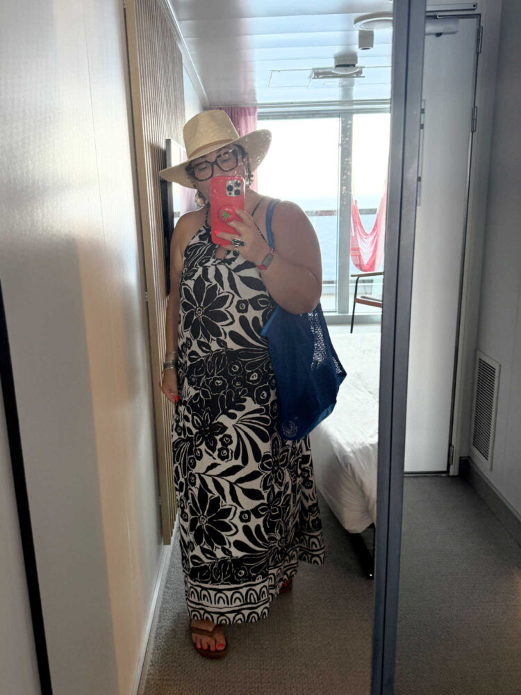What I Wore on My Virgin Voyages Cruise by Wardrobe Oxygen: woman wearing black and white halter dress 