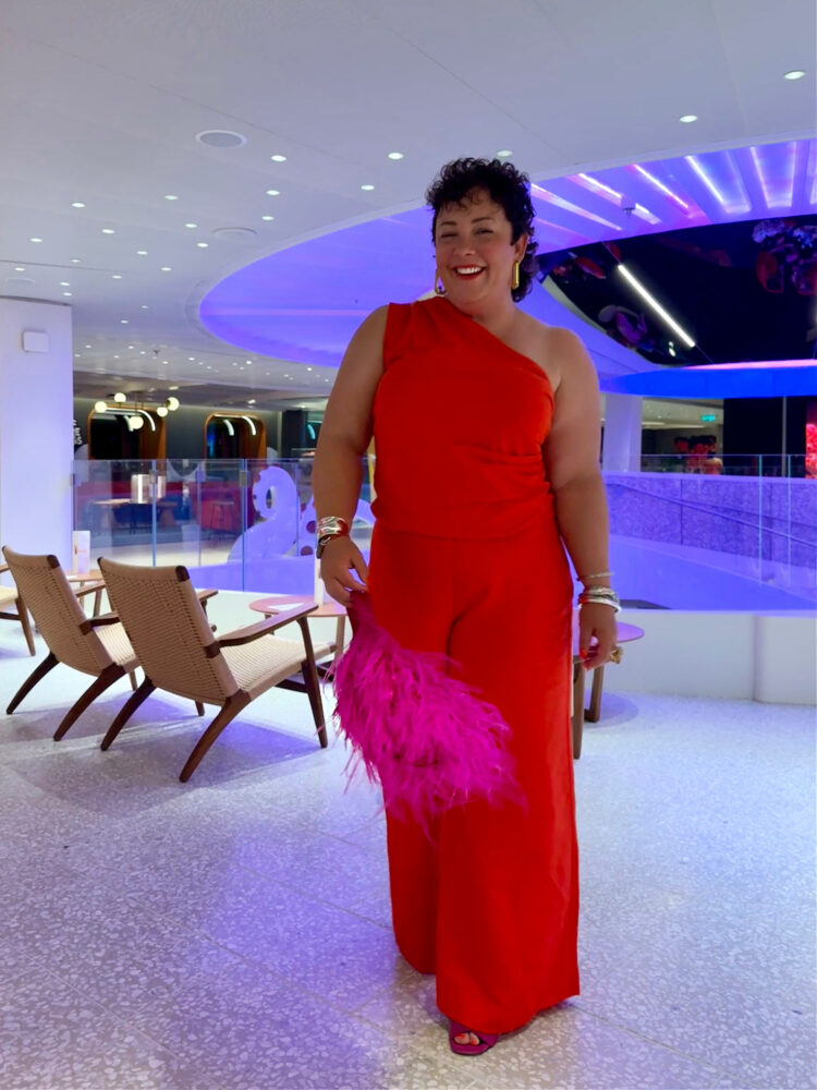 What I Wore on My Virgin Voyages Cruise by Wardrobe Oxygen: woman wearing red jumpsuit for scarlet night on virgin cruise