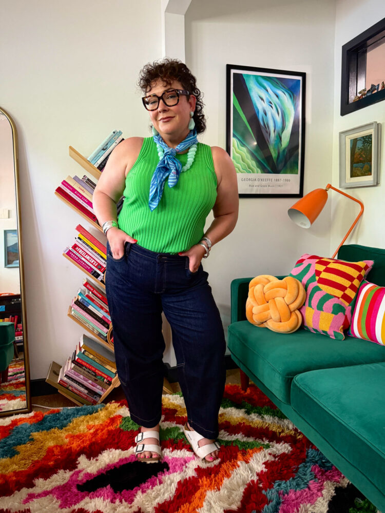 The Best Petite Barrel Jeans for Grown Women 3 wardrobe oxygen wearing a green universal standard sleeveless sweater tucked into ruti barrel jeans