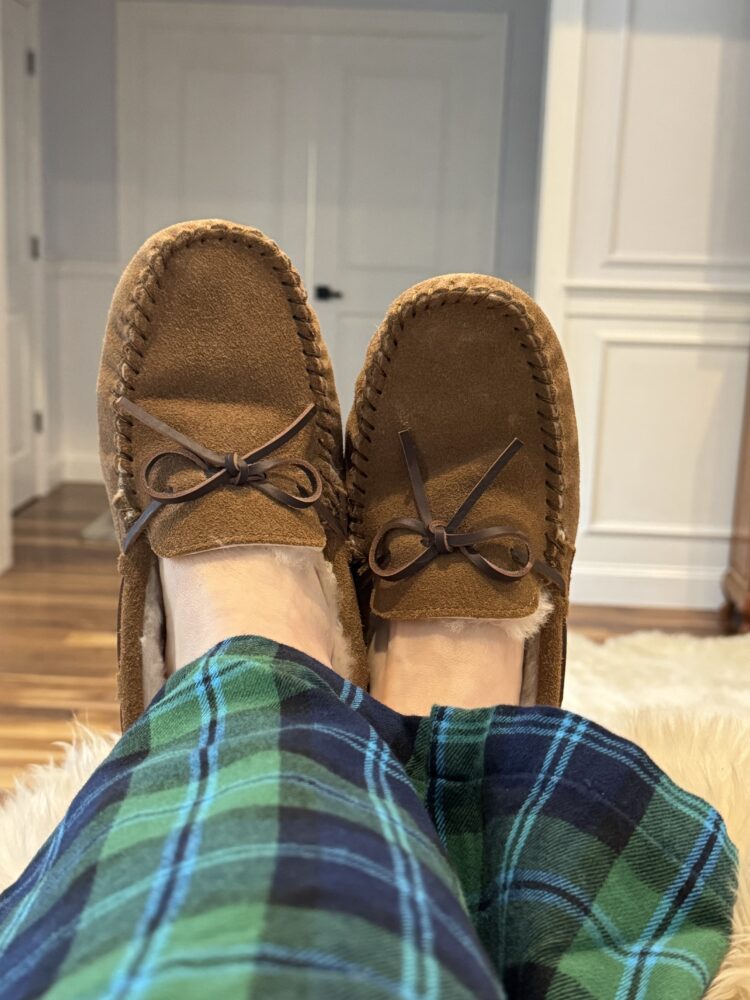 Quince Shoes Review: Italian Leather Boots, Loafers, and Flats Tested by a Real Woman in Her 50s 11 review of the quince sherling moccasin slippers for wardrobe oxygen as seen on a over 50 reviewer who is wearing them with plaid flannel pajamas